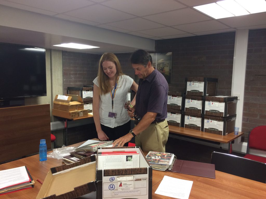 Archivist Beth Williams and John Langley looking at archive material