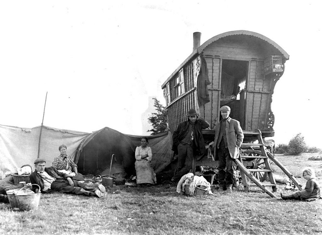 People outside of a traditional Gypsy caravan