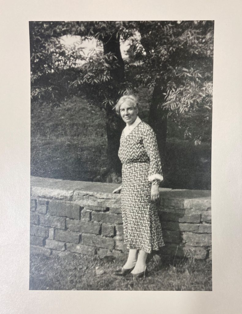 View of Dora Yates standing near a wall.