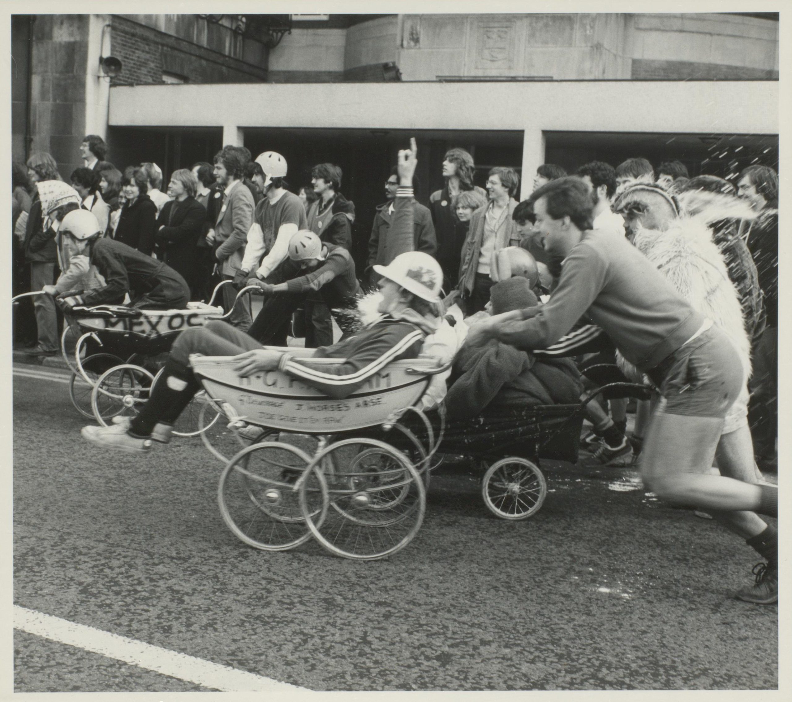 Photograph of University of Liverpool students joining in a pram race during Panto day.