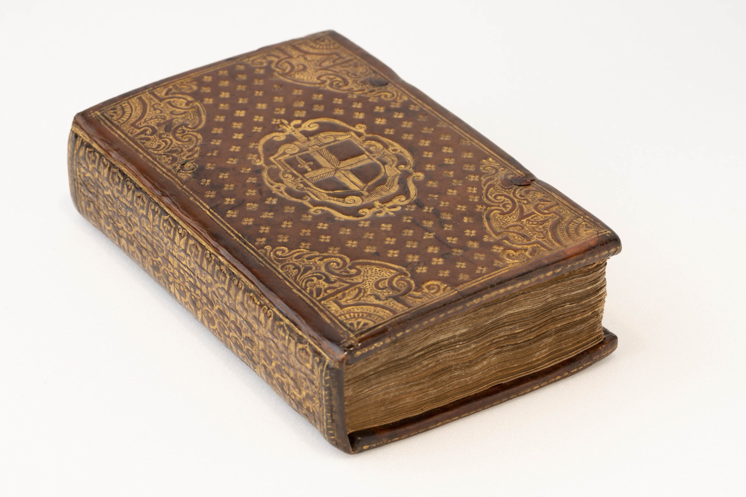 Photograph of a rare book with gilded decorations.